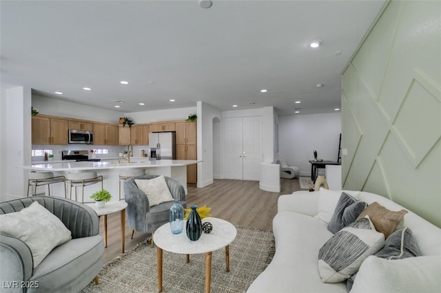 10389 Felice Ave, Las Vegas, NV 89135 - living room featuring light wood-type flooring, recessed lighting, and baseboards