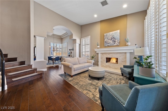 2113 Waterbury Ln, Las Vegas, NV 89134 - living room featuring hardwood / wood-style floors, arched walkways, a high ceiling, recessed lighting, and a chandelier