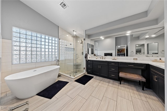 2113 Waterbury Ln, Las Vegas, NV 89134 - full bathroom with vanity, a stall shower, a freestanding tub, and tile walls