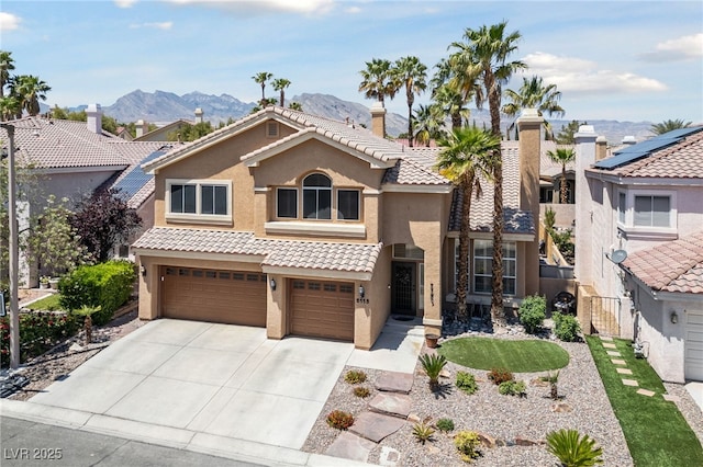 2113 Waterbury Ln, Las Vegas, NV 89134 - view of front of home with stucco siding, concrete driveway, a garage, and a mountain view