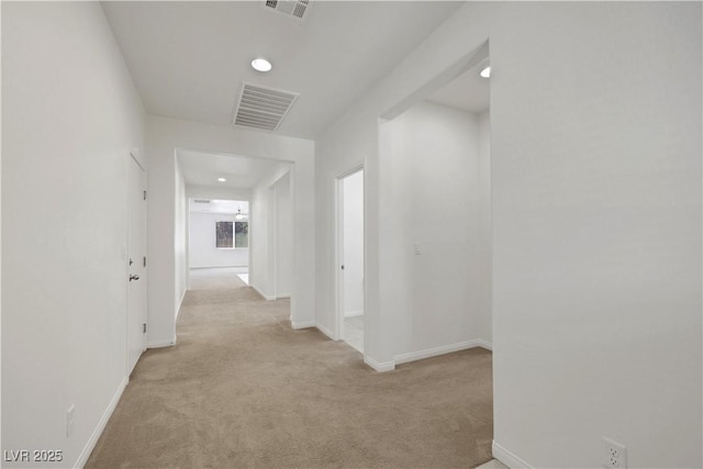 hallway with light carpet, baseboards, and recessed lighting