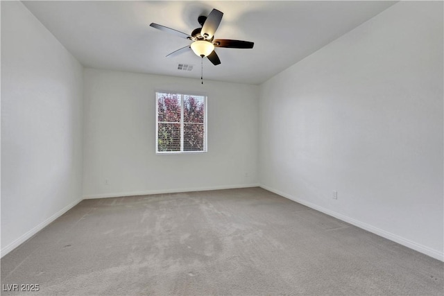 spare room with carpet flooring, ceiling fan, and baseboards