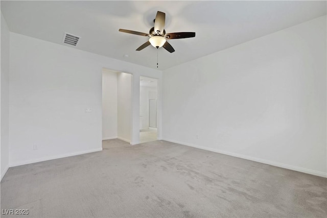 empty room with ceiling fan, carpet floors, and baseboards