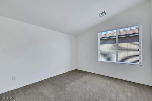 empty room with lofted ceiling, carpet, and baseboards
