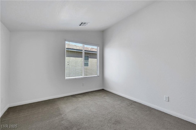 unfurnished room featuring carpet flooring, vaulted ceiling, and baseboards