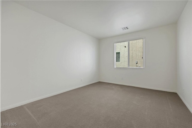 spare room with carpet flooring and baseboards
