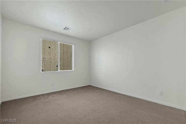 unfurnished room featuring baseboards and carpet floors