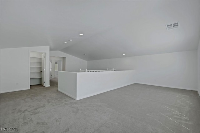 additional living space featuring vaulted ceiling, carpet floors, baseboards, and recessed lighting