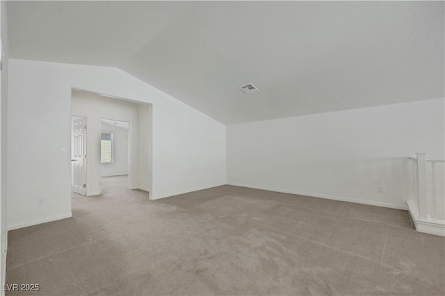 additional living space with lofted ceiling, carpet flooring, and baseboards