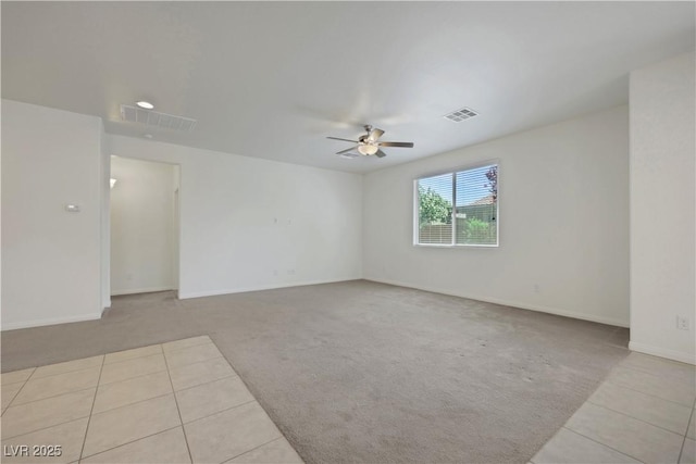 carpeted spare room featuring a ceiling fan, tile patterned floors, baseboards, and recessed lighting