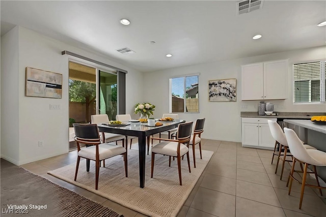 dining area featuring light tile patterned floors and recessed lighting