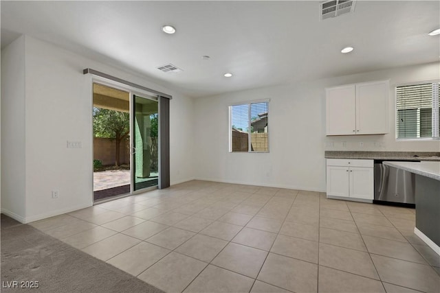 kitchen with dishwasher, white cabinets, light tile patterned floors, recessed lighting, and baseboards