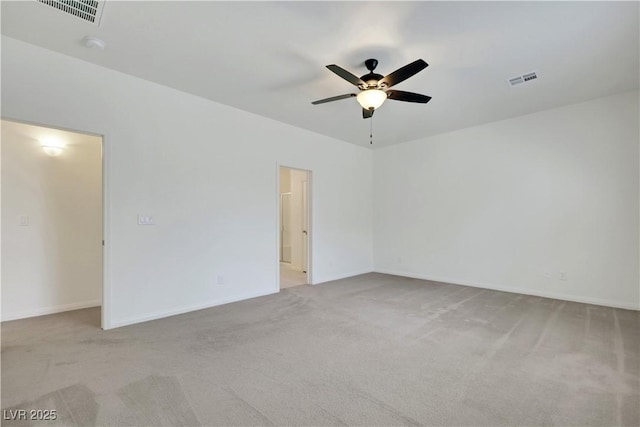 spare room with ceiling fan, carpet, and baseboards