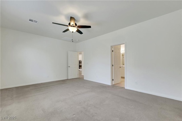 carpeted spare room featuring ceiling fan and baseboards