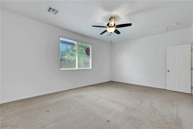 carpeted empty room featuring ceiling fan and baseboards