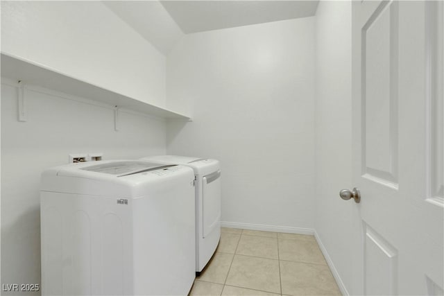 washroom featuring independent washer and dryer, baseboards, and light tile patterned floors