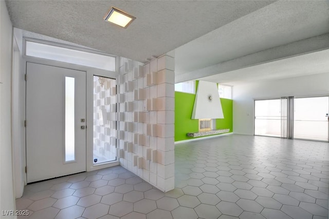 tiled entrance foyer with a textured ceiling