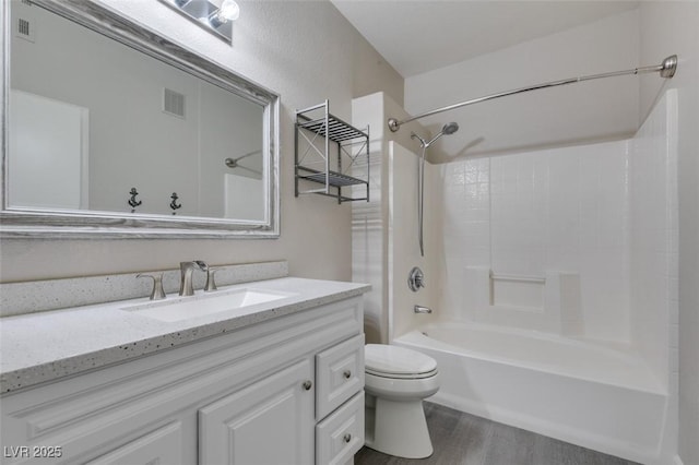 full bath with wood finished floors, toilet, vanity, and shower / bathtub combination
