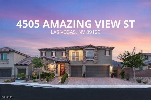 4505 Amazing View St, Las Vegas, NV 89129 - view of front of property with stone siding, an attached garage, stucco siding, a tiled roof, and driveway
