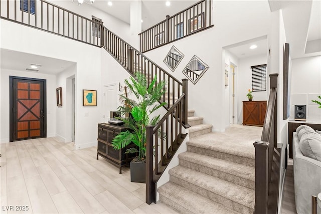4505 Amazing View St, Las Vegas, NV 89129 - stairs featuring baseboards, a towering ceiling, recessed lighting, and wood finished floors