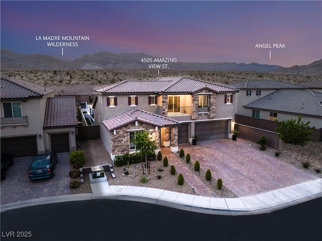 4505 Amazing View St, Las Vegas, NV 89129 - mediterranean / spanish-style house with a garage, a tile roof, stucco siding, decorative driveway, and stone siding