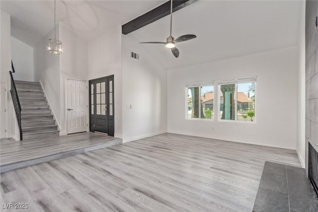 326 Fuente Dr, Henderson, NV 89014 - foyer entrance with stairway, wood finished floors, beamed ceiling, high vaulted ceiling, and a chandelier