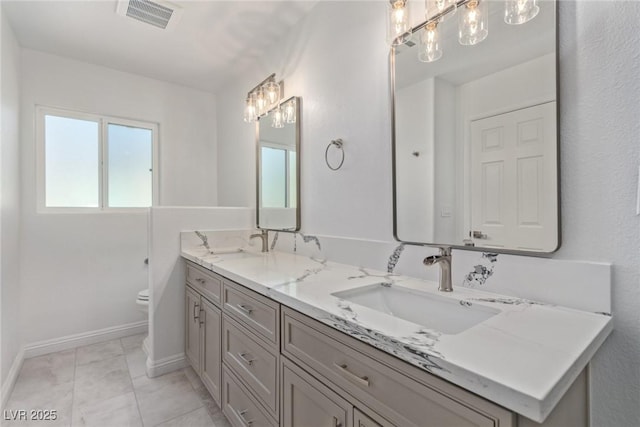 326 Fuente Dr, Henderson, NV 89014 - full bath with double vanity, toilet, baseboards, and marble look tile flooring