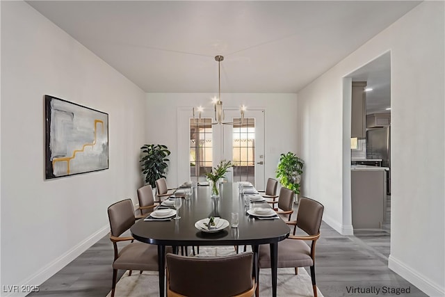 326 Fuente Dr, Henderson, NV 89014 - dining room featuring baseboards, wood finished floors, and a chandelier