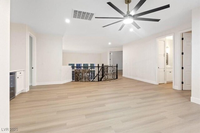 spare room with a ceiling fan, light wood-style floors, baseboards, and recessed lighting