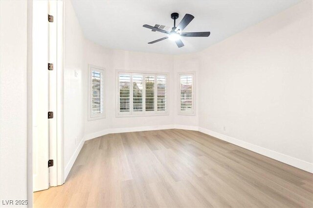 unfurnished room with light wood finished floors, ceiling fan, and baseboards
