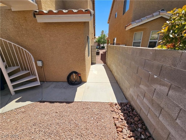 view of property exterior with fence and stucco siding