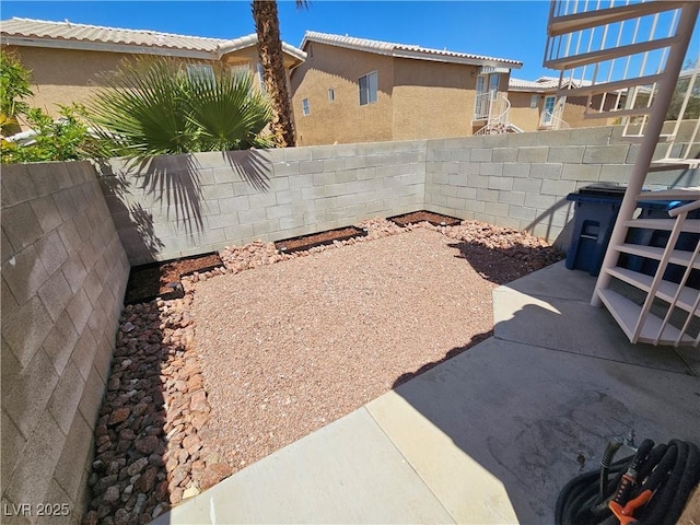 fenced backyard featuring a patio