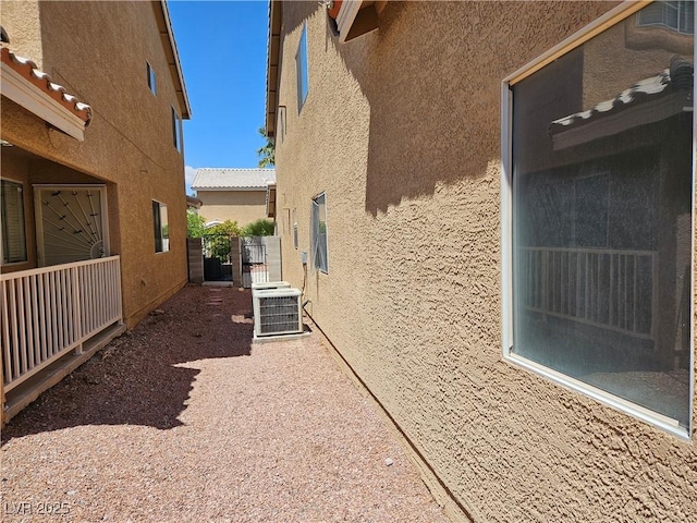 view of property exterior with stucco siding and central AC