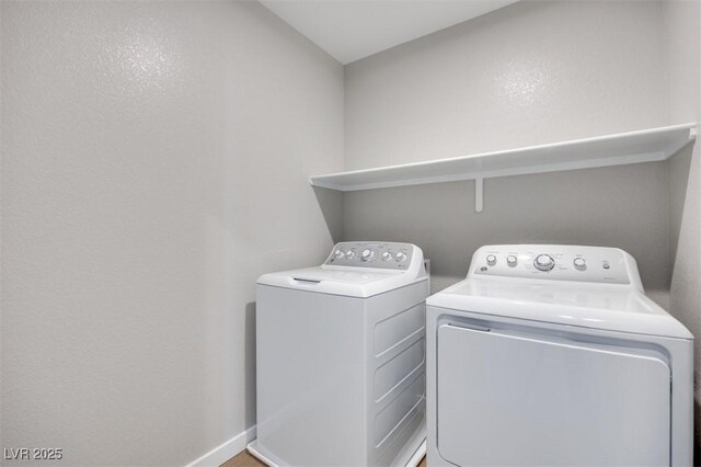 washroom featuring independent washer and dryer and baseboards