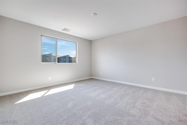 unfurnished room with carpet and baseboards