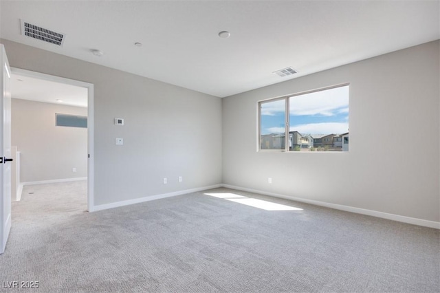unfurnished room with carpet floors and baseboards