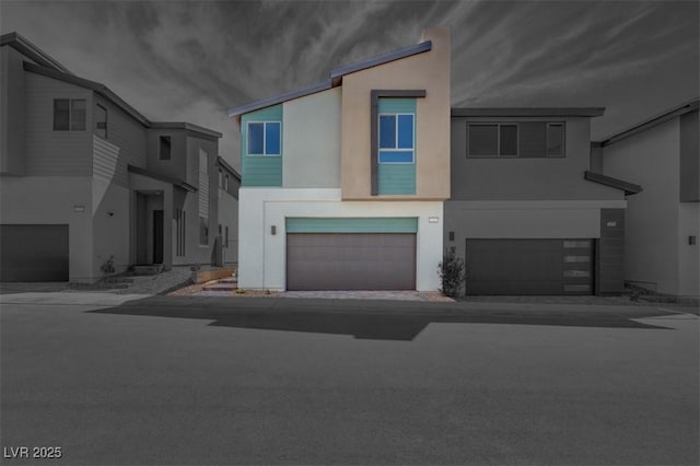 view of property featuring a garage and stucco siding