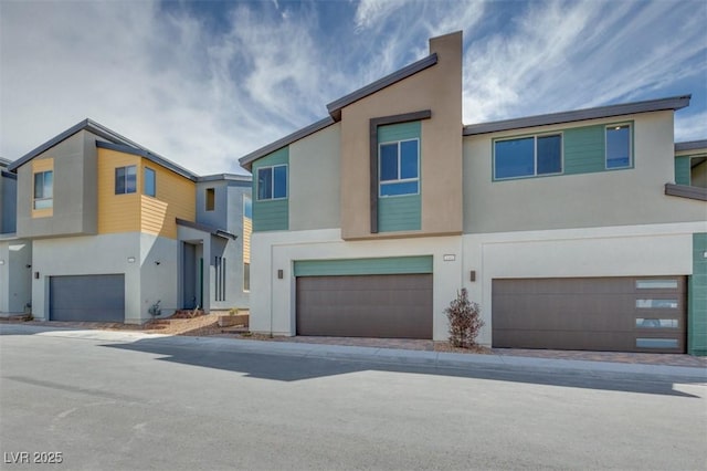 view of property with a garage and stucco siding