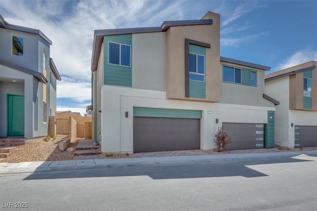 view of front of home featuring an attached garage and stucco siding