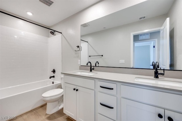 bathroom with toilet, double vanity, and  shower combination