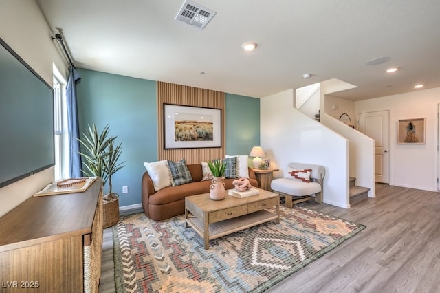 living area featuring stairway, recessed lighting, wood finished floors, and baseboards