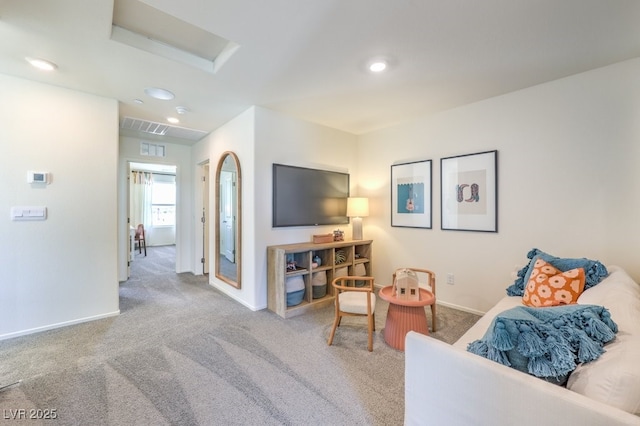carpeted living area featuring baseboards and recessed lighting
