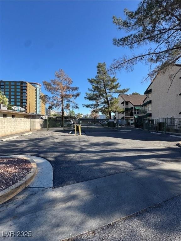 view of asphalt road with curbs