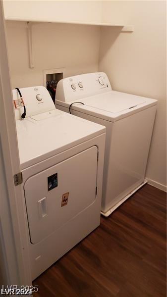 clothes washing area featuring washer and dryer and dark wood-style flooring