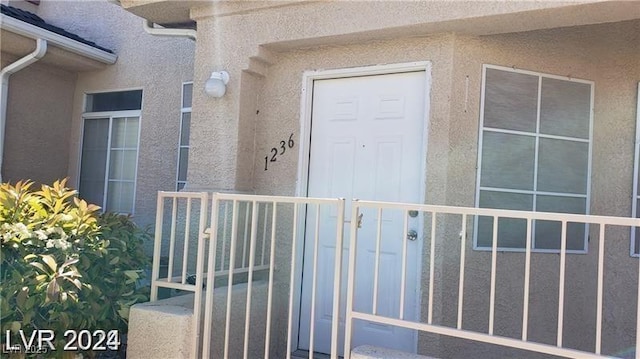 property entrance with stucco siding