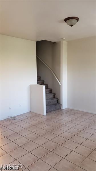 stairway with tile patterned floors