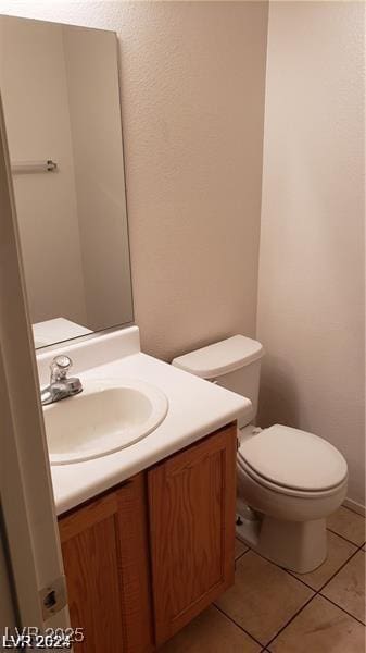 bathroom with vanity, toilet, and tile patterned flooring