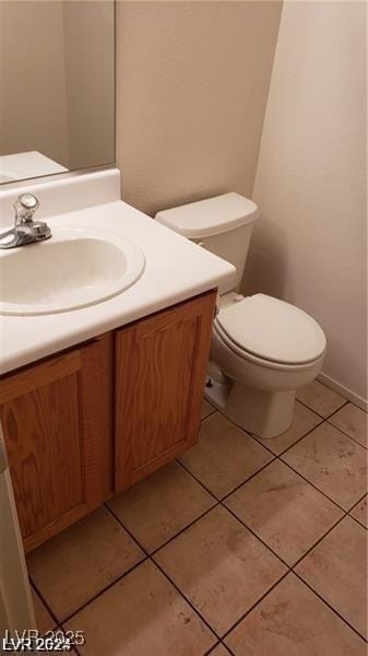 bathroom featuring vanity, toilet, and tile patterned floors