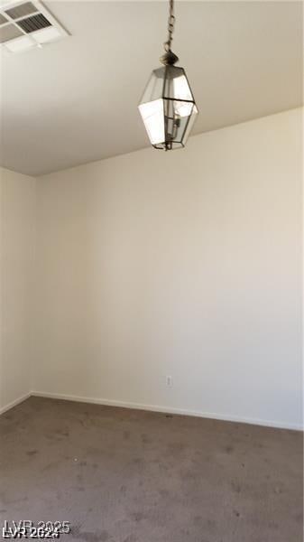 carpeted empty room featuring baseboards