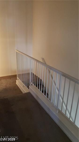 stairs featuring carpet floors and baseboards